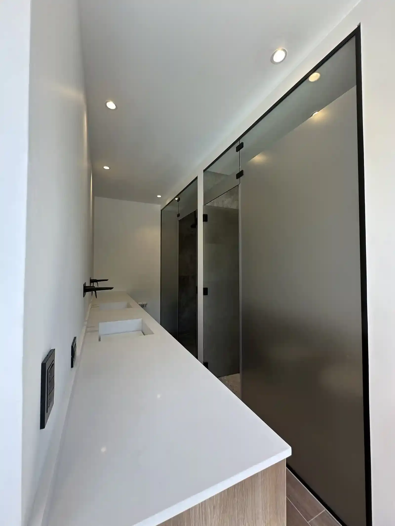 Baño de Casa Adrogué con mesada continua y divisiones vidriadas